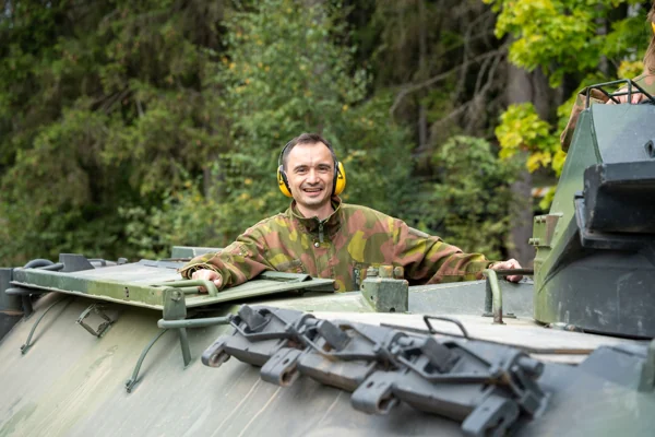 A man in a tank hatch