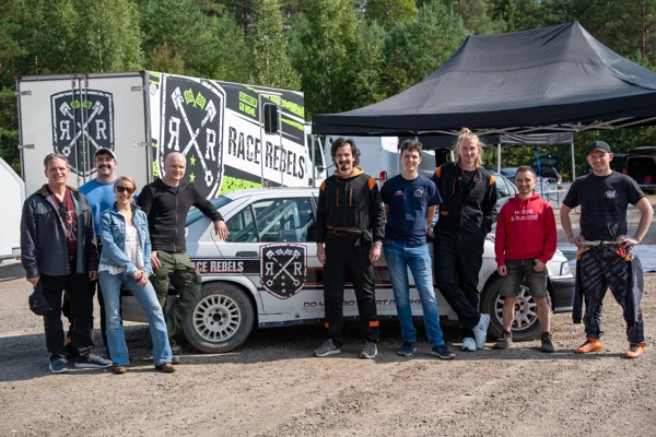 The Summer Mayhem group in front of rally cars