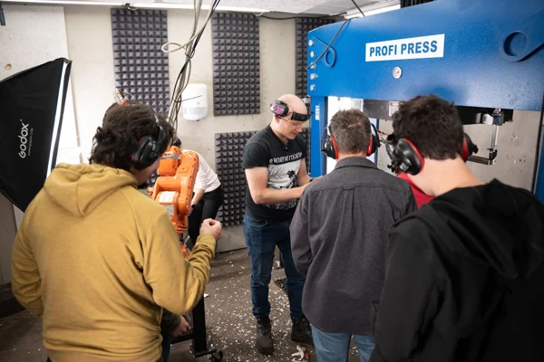Visitors beside the hydraulic press